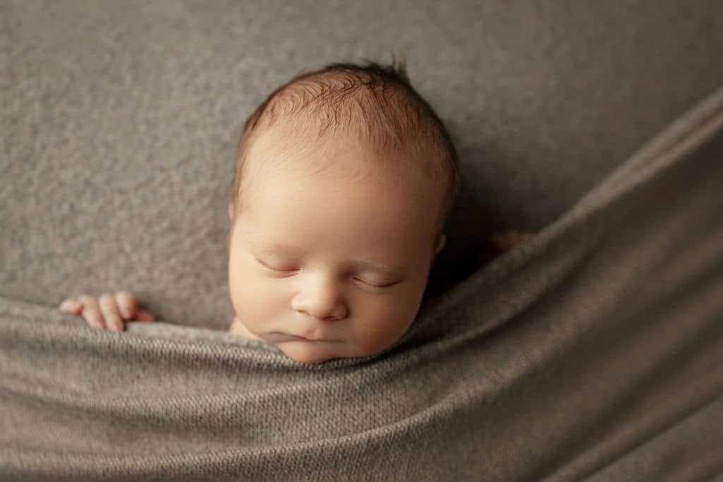 sweet newborn baby boy in tan