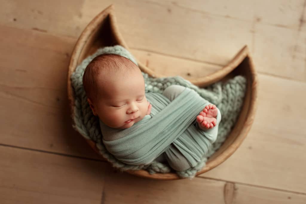 newborn baby boy in moon basket