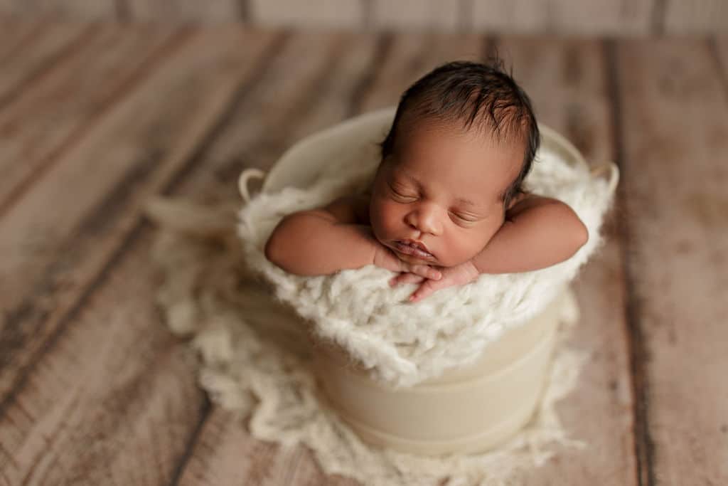 newborn baby boy in a bucket