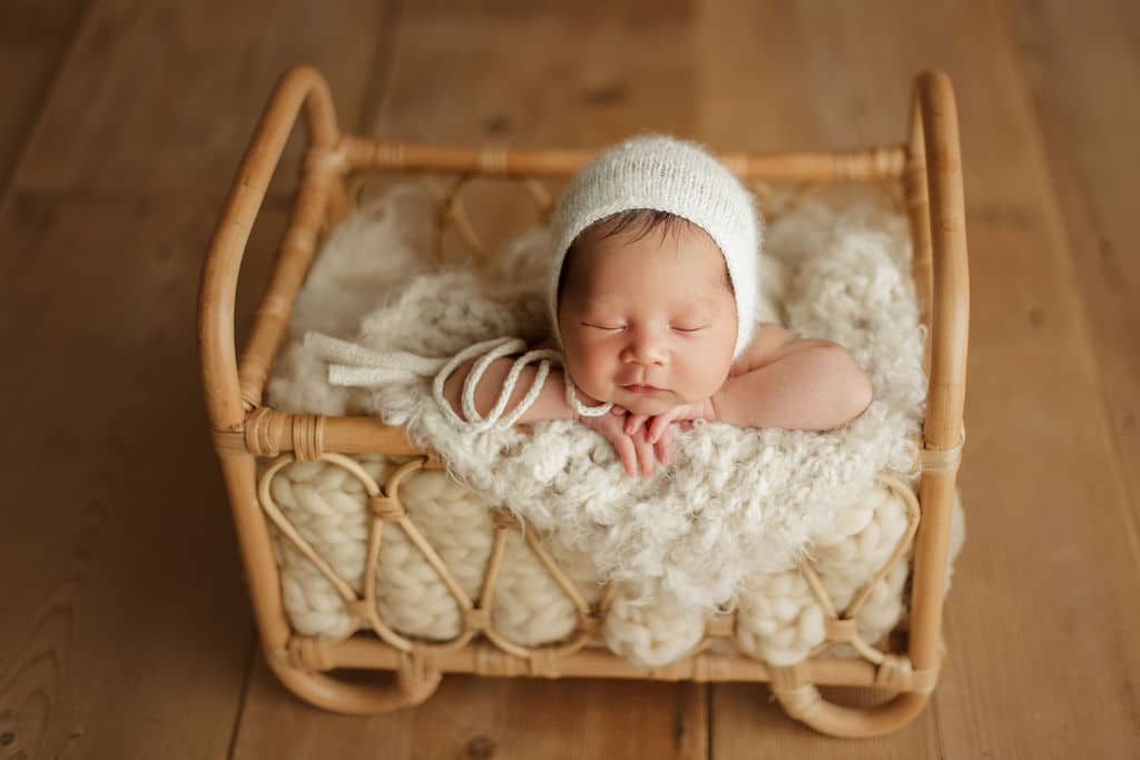 newborn boy in small bed