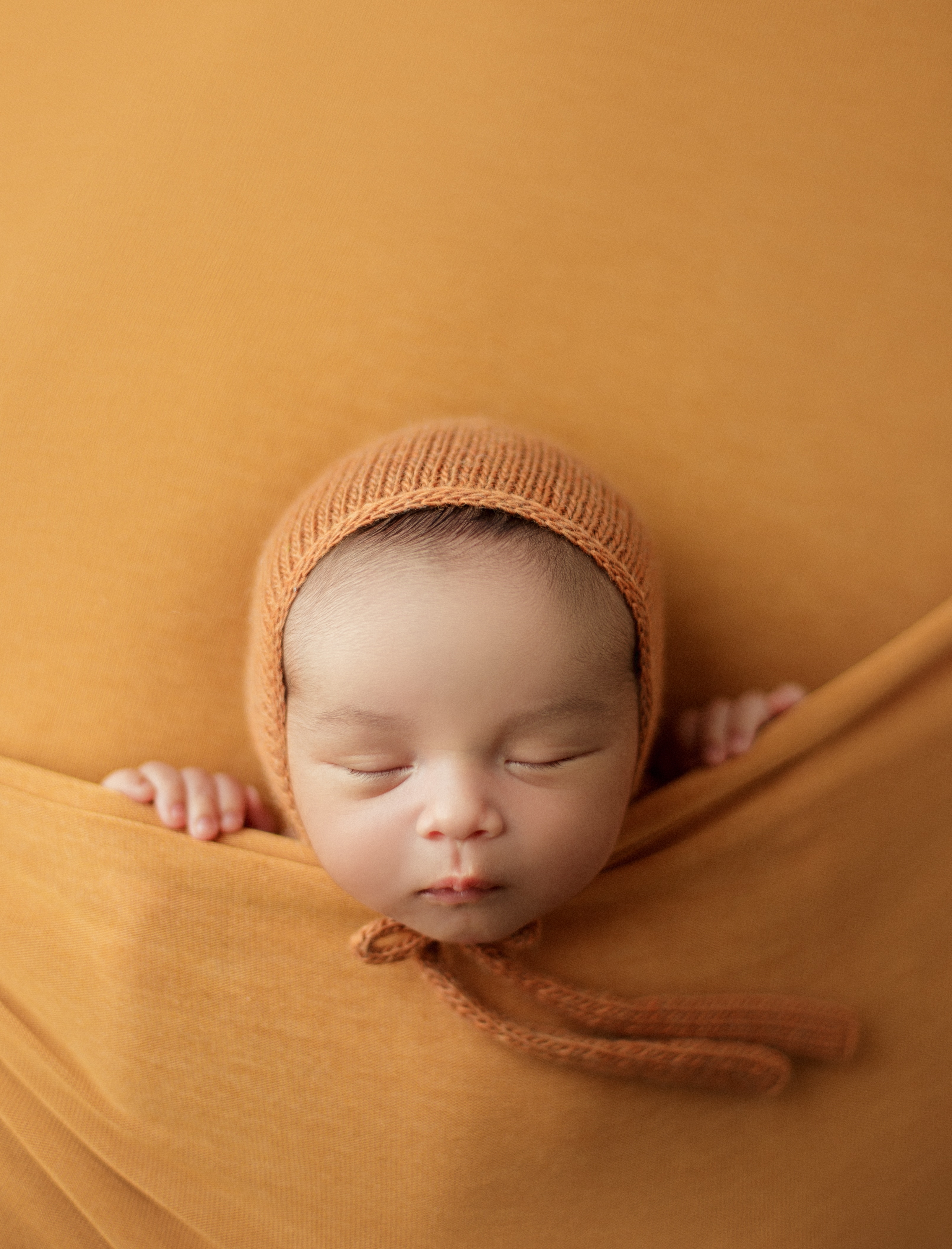 newborn baby in orange tones