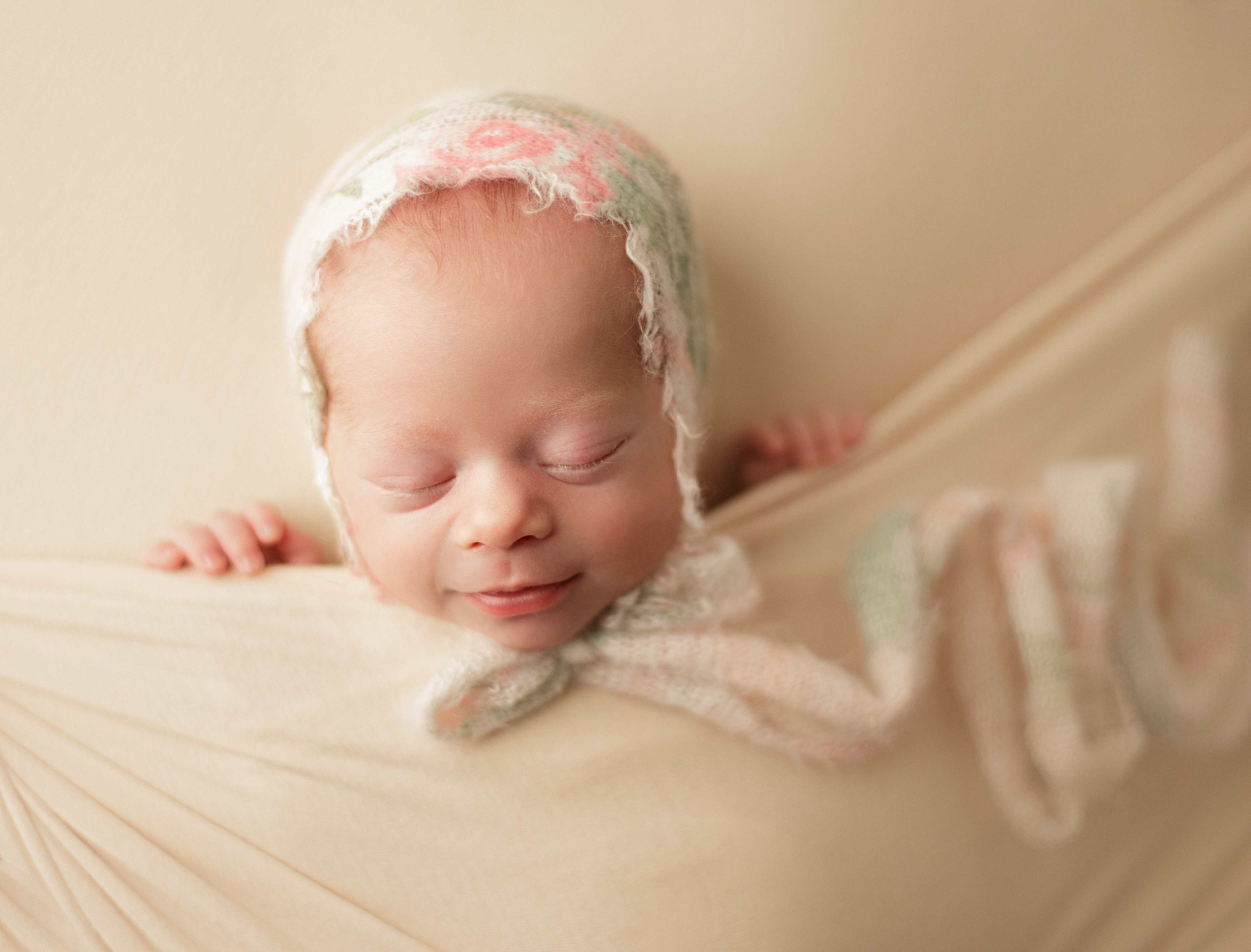 newborn baby girl with a smile