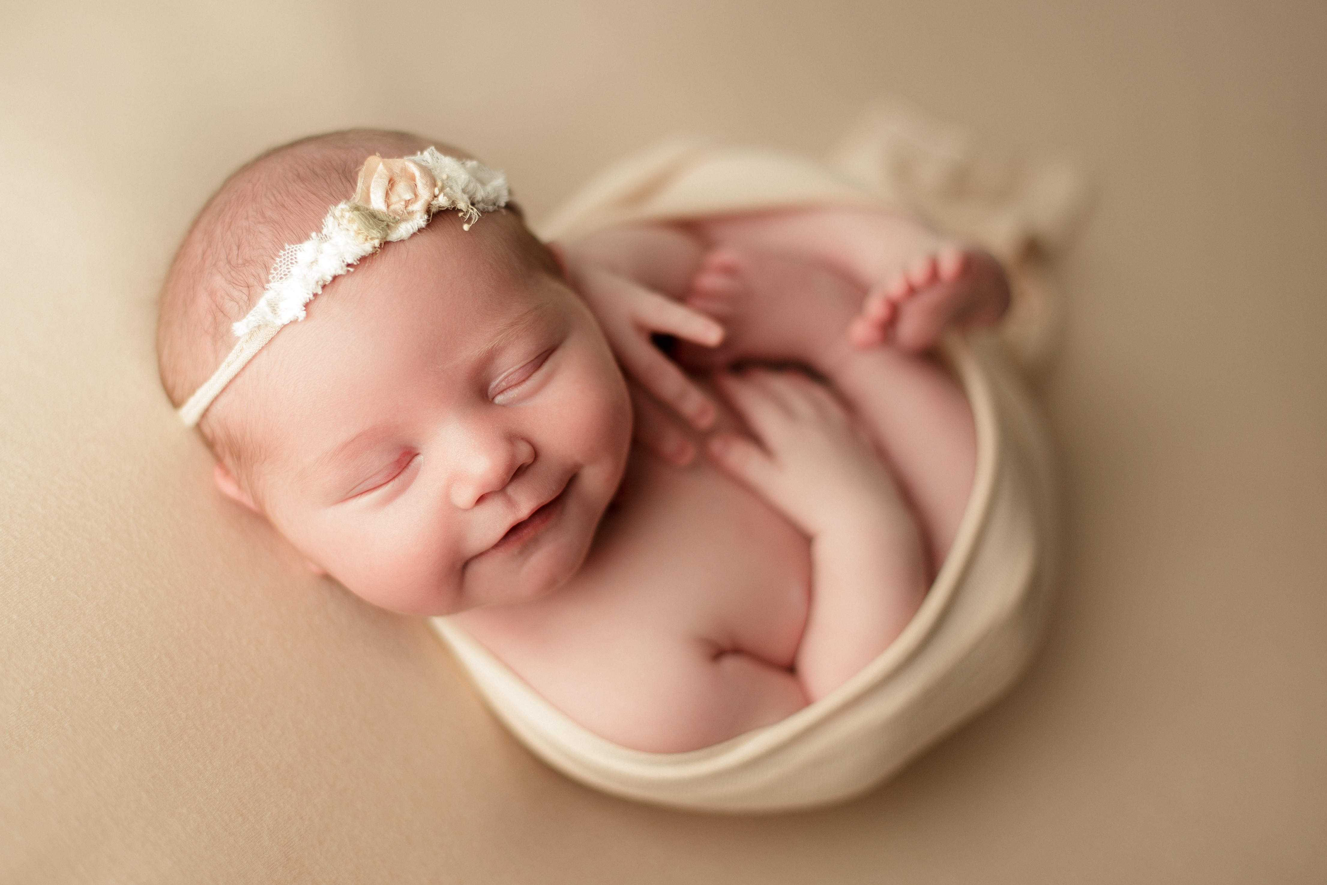 smiling and sleeping newborn baby girl