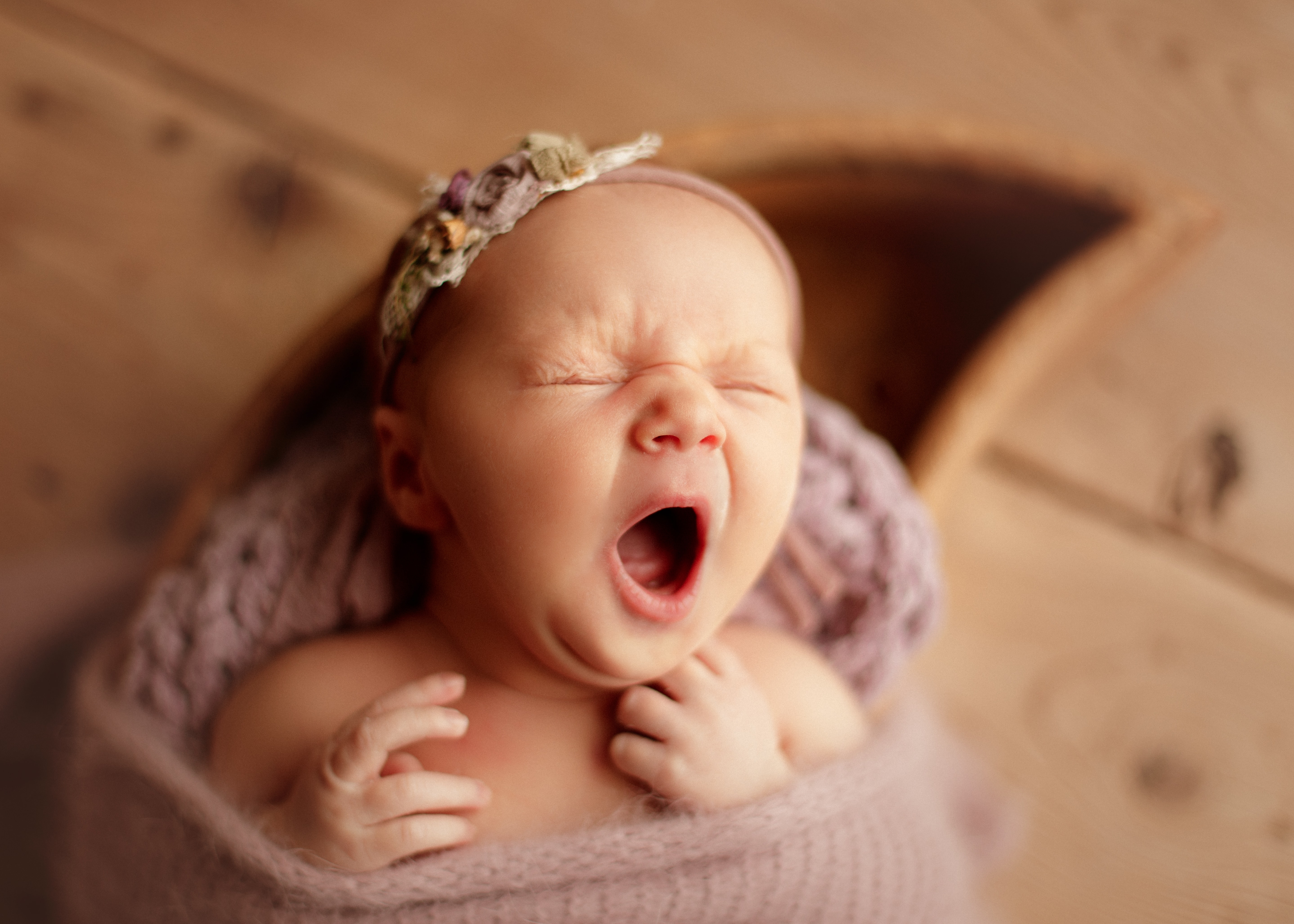 yawning baby at newborn photo shoot