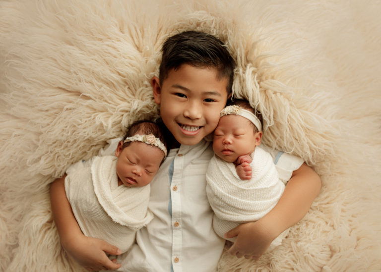 big brother with twin baby sisters
