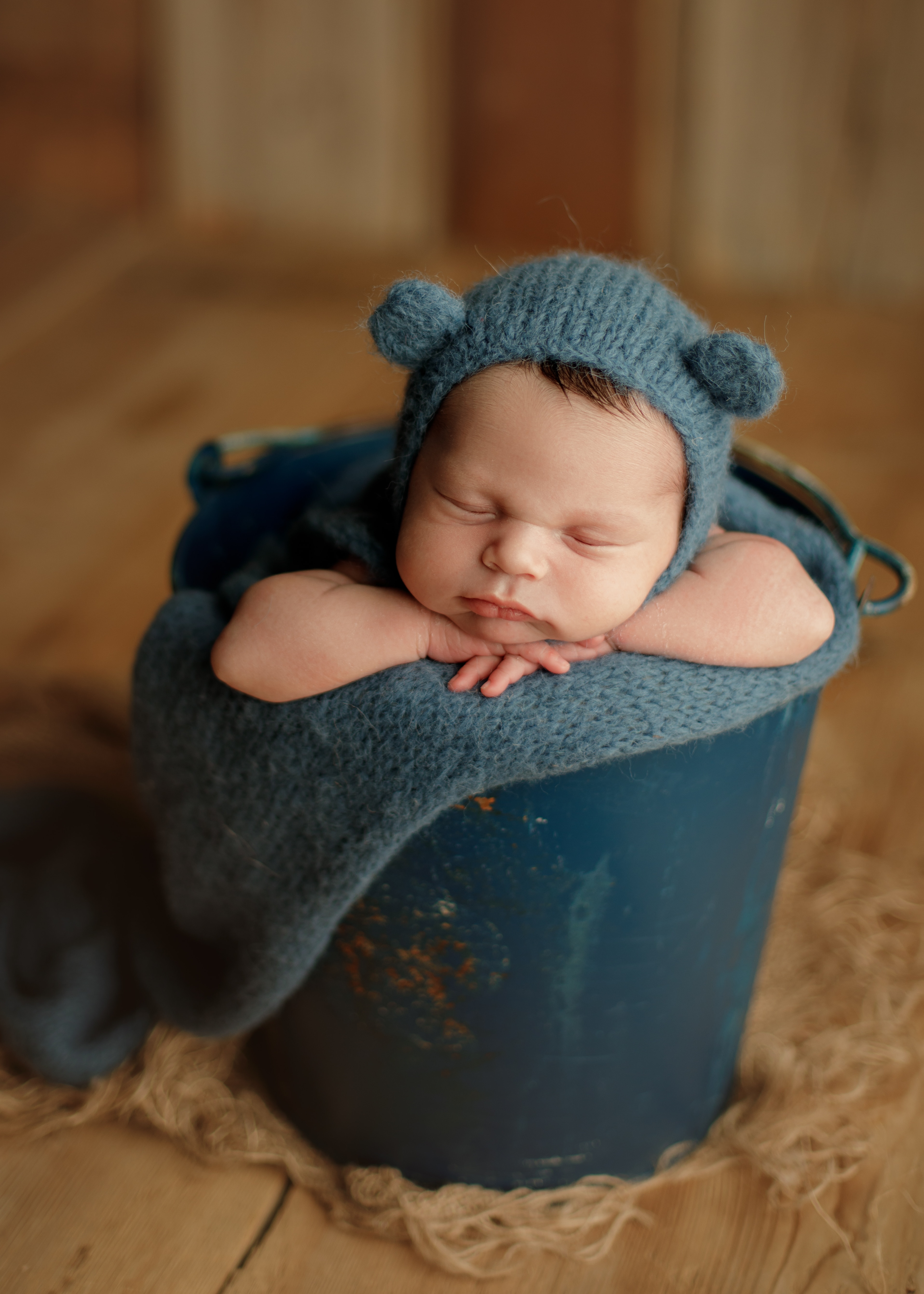 baby boy in bucket, newborn photo shoot