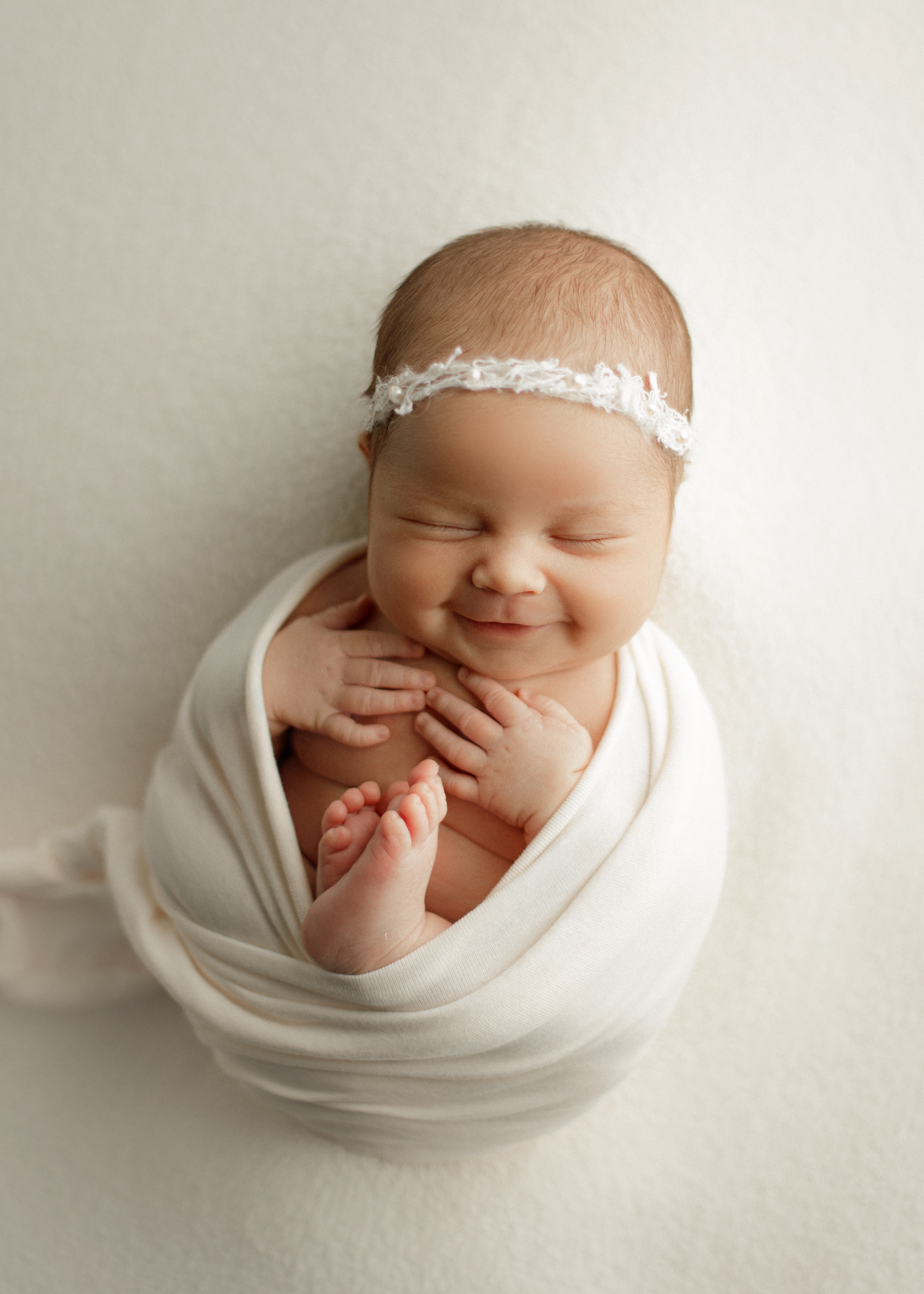 happy newborn baby smiling at Chicago newborn photo shoot