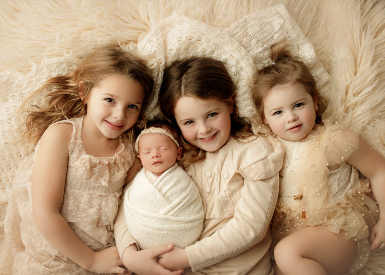 four sisters at newborn photo shoot